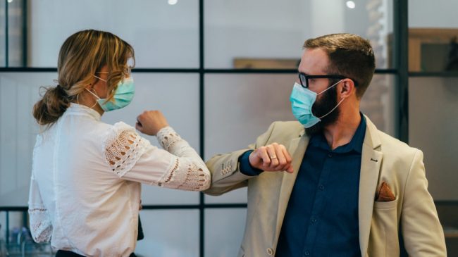 Business people greeting during COVID-19 pandemic