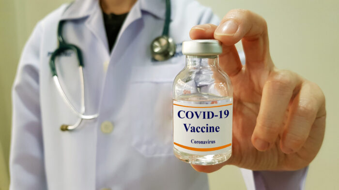 Infectious doctor show COVID 19 vaccine for prevention,immunization and treatment for new corona virus infection(COVID-19,novel coronavirus disease 2019 or nCoV 2019 from Wuhan). Medical technology.