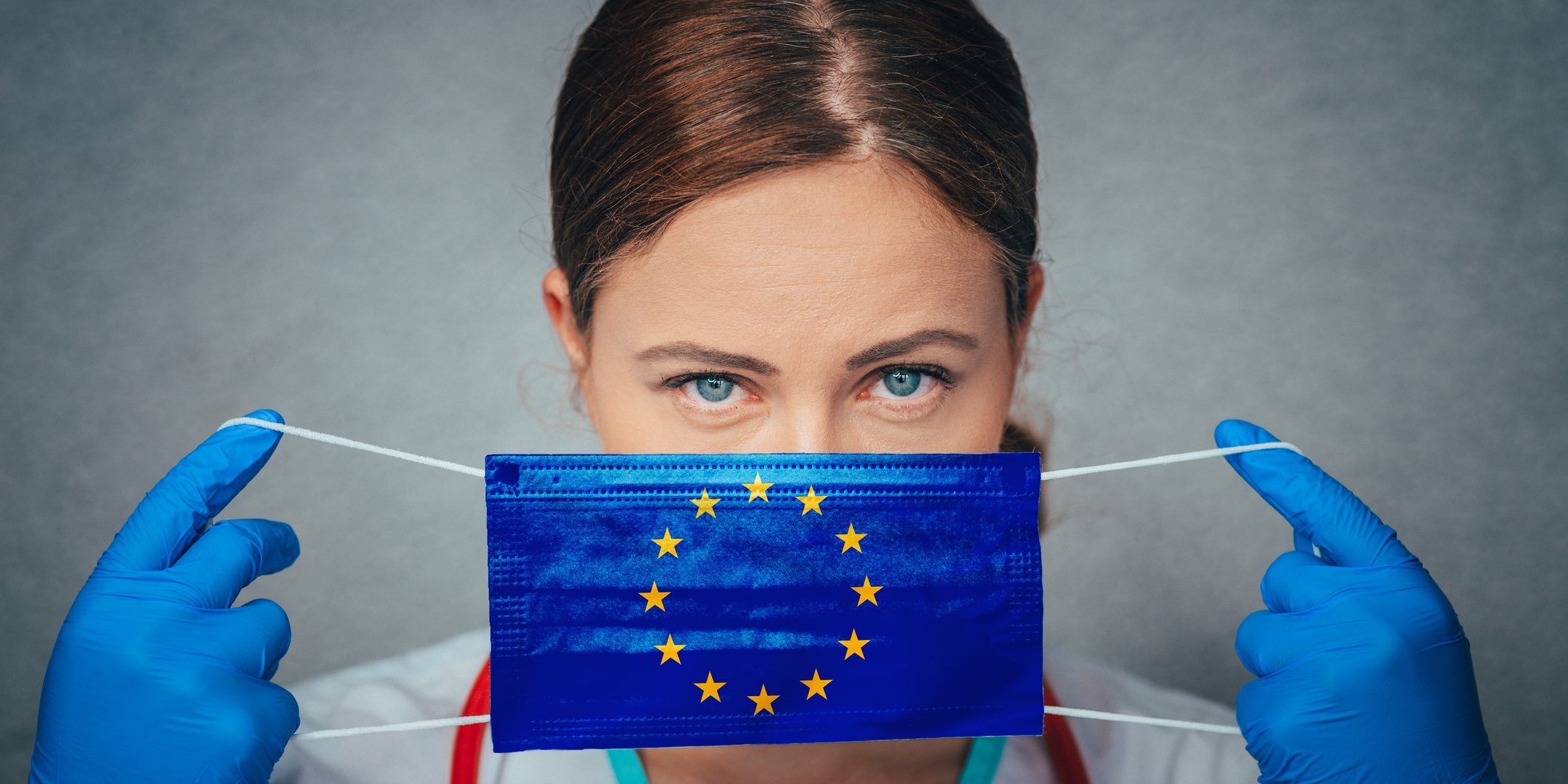 Coronavirus in European Union, Female Doctor Portrait hold protect Face surgical medical mask with Europa Union Flag. Illness, Virus Covid-19 in EU, concept photo