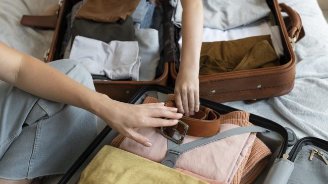 mother-and-son-preparing-suitcase-for-their-holiday